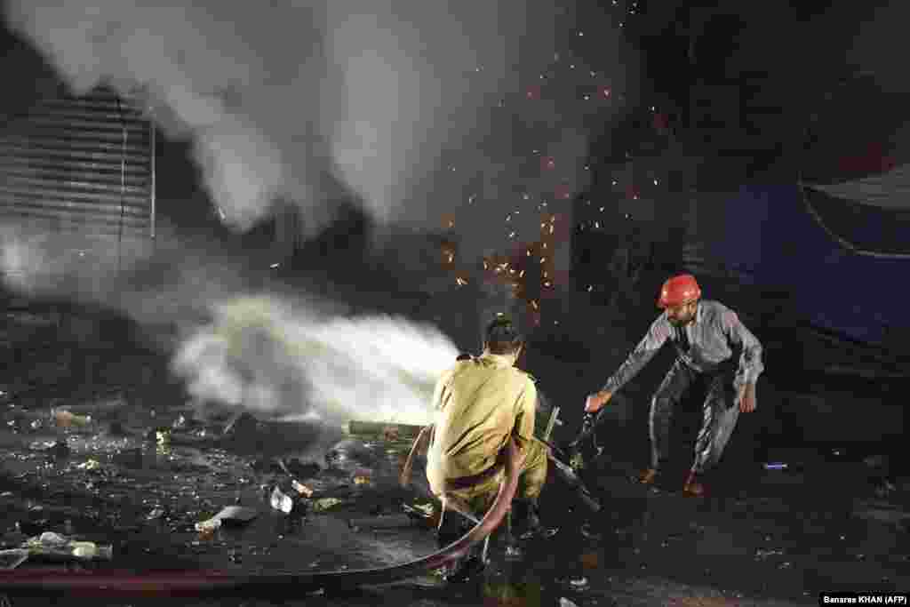 Pakistani firefighters try to extinguish a blaze at the site of an explosion in a market area in Quetta on March 2.&nbsp;