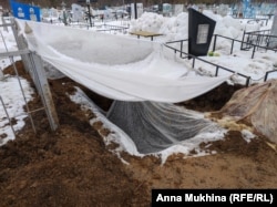 This is the grave of Maksim Khanygin, but his body is not here -- and may not be laid to rest before Russia's war in Ukraine is over.