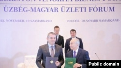 Ўзбекистон-Венгрия форумида имзоланган ҳужжатлар билан алмашиш пайти.
