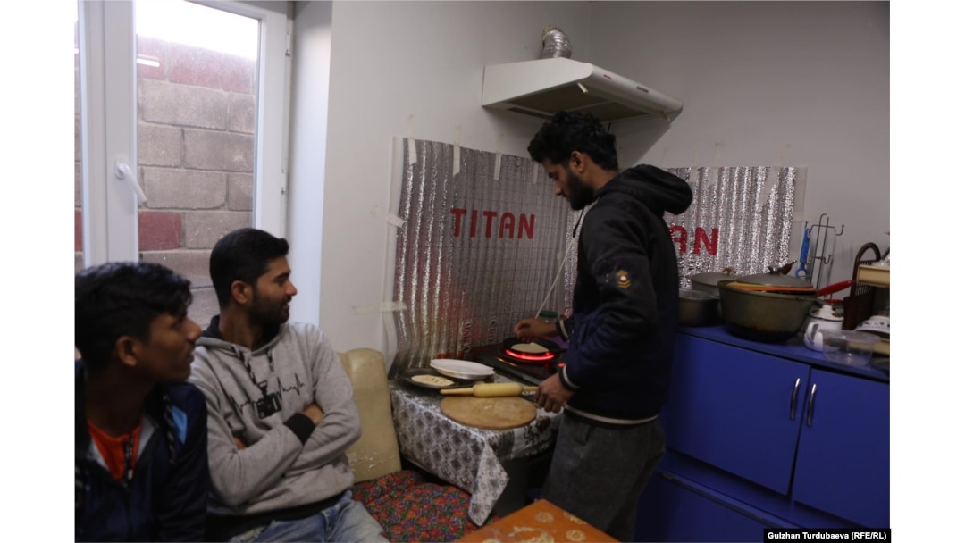 Bangladeshis who came to work in Kyrgyzstan prepare a meal at a Bishkek apartment.