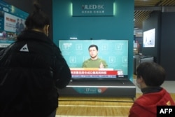 A TV screen shows news about Russia's invasion of Ukraine at a shopping mall in Hangzhou, China, on February 25, 2022.