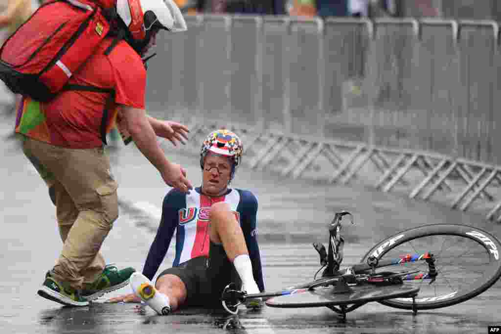 U.S. cyclist Kristin Armstrong falls after finishing the women's individual time trial event.