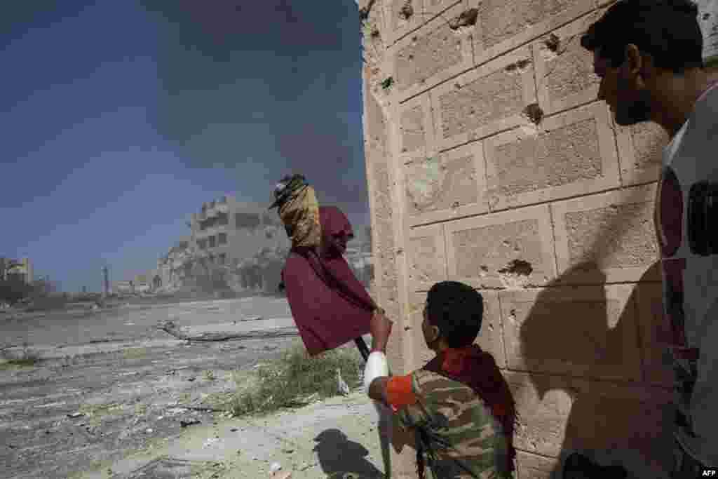 A supporter of the Libyan Government of National Accord uses a dummy to catch the attention of Islamic State snipers at the front line in Sirte. (AFP/Fabio Bucciarelli)