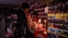 People shop in a store during a blackout in Crimea on November 26.