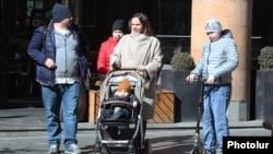 Armenia - A Russian family strolls in downtown Yerevan, March 7, 2022.