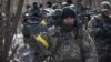 Ukrainian troops get ready to take part in an operation against Russian forces in a settlement near Kyiv.&nbsp;