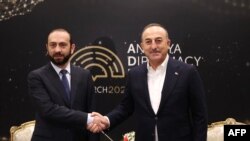 TURKEY - Turkey's Foreign Minister Mavlut Cavusoglu (R) shakes hands with Armenia's Foreign Minister Ararat Mirzoyan during the Antalya Diplomacy Forum (ADF) in Antalya, March 12, 2022.