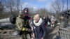 People evacuate from Irpin, near Kyiv, as Russia's invasion of Ukraine continues, March 9, 2022.