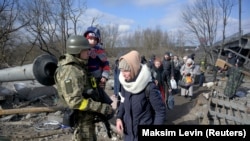 People evacuate from Irpin, near Kyiv, as Russia's invasion of Ukraine continues, March 9, 2022.