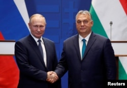 Russian President Vladimir Putin and Orban pose following talks in Budapest in October 2019.