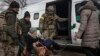 An elderly woman is evacuated from Irpin in the Kyiv region on March 9. 