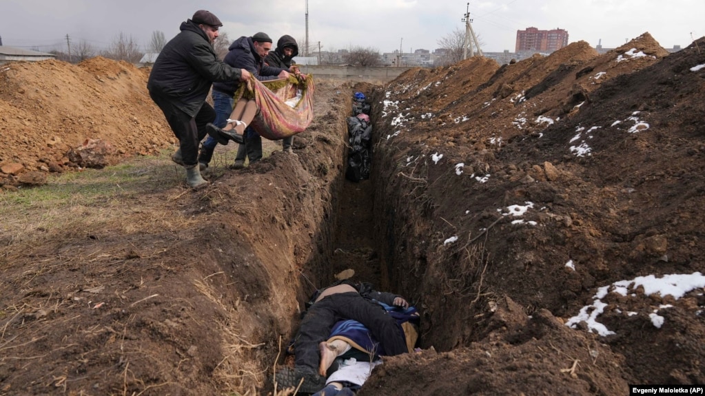 Dead bodies are put into a mass grave on the outskirts of Mariupol, Ukraine, on March 9 as people cannot bury their dead because of the heavy shelling by Russian forces.