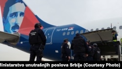 Officials investigate a bomb threat on an Air Serbia flight to Moscow in Belgrade on March 15.