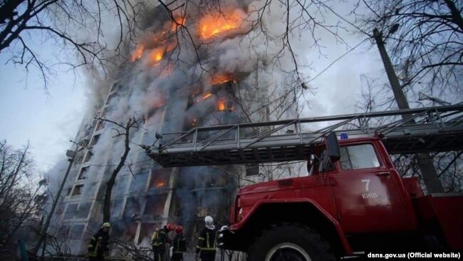 Firefighters at the scene after Russian shelling of an apartment building in the Svyatoshyn district of Kyiv on March 15.