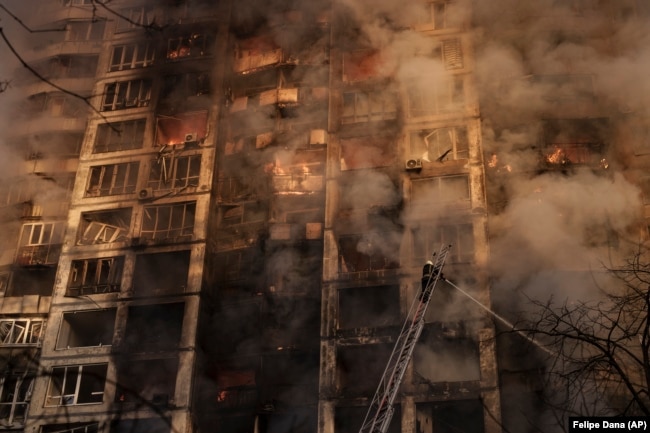 Firefighters tackle blazes in an apartment building after it was hit by shelling in Kyiv on March 15.