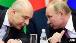 Russian Finance Minister and Security Council member Anton Siluanov (left), pictured speaking with President Vladimir Putin, is one of the people emphasized on the list. 