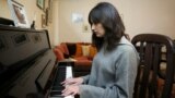 UKRAINE-CRISIS/SYRIA-ANNIVERSARY/Victoria Naji, born in Syria to a Palestinian father and a Ukrainian mother, plays the piano at her home in Damascus, Syria March 12, 2022. Picture taken March 12, 2022. 