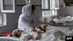 Wounded Afghan students of the American University of Afghanistan receive treatment at a hospital in Kabul on August 25.