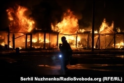 A fire rips through the book market near the Pochayna Metro station in Kyiv after a Russian strike on August 16.