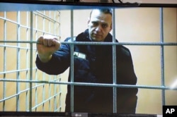 Aleksei Navalny looks at a camera while speaking from prison via video link during a court session in January.