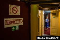 An actress rehearses her lines in an underground corridor in the Mykolayiv Drama Theater on August 25. A sign on the left points in the direction of the theater's bomb shelter.