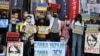 People hold placards during a protest against Russia's invasion of Ukraine outside the Russian representative office in Taipei on March 1.
