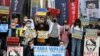 Njerëzit mbajnë pankarta gjatë një proteste kundër pushtimit rus të Ukrainës jashtë zyrës së përfaqësueses ruse në Taipei. 1 mars 2022.