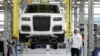An employee checks an Aurus Senat car on an assembly line at a manufacturing plant in the town of Yelabuga in Russia's Tatarstan region. 