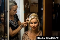 A stylist helps an actress prepare for the August 25 performance.