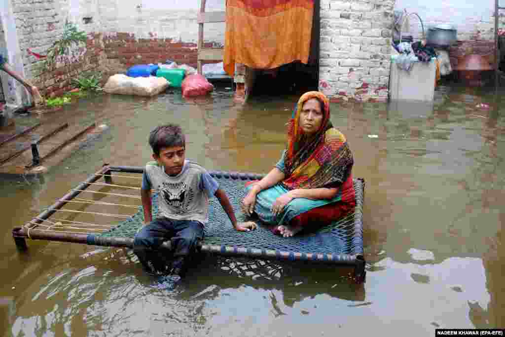 People affected by monsoon rains waits for relief in Hyderabad, Pakistan.