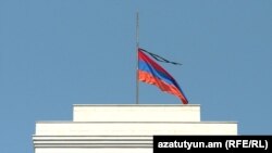 Armenia’s national flag on a government building in Yerevan flying at half-staff with a black ribbon as the country observes a two-day mourning for victims of the August14 market explosion.