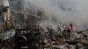 People help firefighters extinguish a fire after blasts ripped through a fireworks warehouse at a shopping mall in Yerevan on August 14.