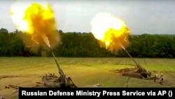 Russian Malka artillery systems fire from an undisclosed location in Ukraine.