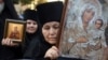 An Orthodox nun holds an icon during a protest against the international LGBT event EuroPride in Belgrade on August 28.