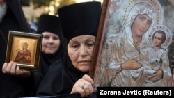 An Orthodox nun holds an icon during a protest against the international LGBT event EuroPride in Belgrade on August 28.