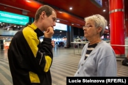 Svitlana Pisarskaya and her son, Viktor, discuss what to do next at Prague's main railway station.