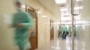 Blurred doctor figures wearing medical uniforms are seen in the governmental hospital "Lozenets" corridor in Sofia, Bulgaria, June 1, 2015.