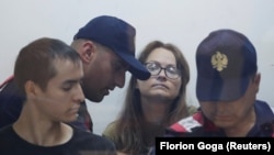 Russians Mikahil Zorin (left) and Svetlana Timofeyeva appear in court in Elbasan, Albania, in August 2022. 