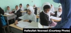 Younger girls study in a class in Farah Province.