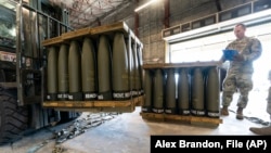 A U.S. Air Force serviceman checks pallets of 155-millimeter shells ultimately bound for Ukraine as part of an aid package for the embattled country. (file photo)