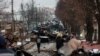 Civilians look at a destroyed Russian armored column in Bucha, near Kyiv, in a photo taken by RFE/RL photographer Serhiy Nuzhnenko in March 2022.