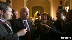 U.S. Senator Susan Collins (center) is interviewed by reporters alongside Senator John McCain in the U.S. Capitol