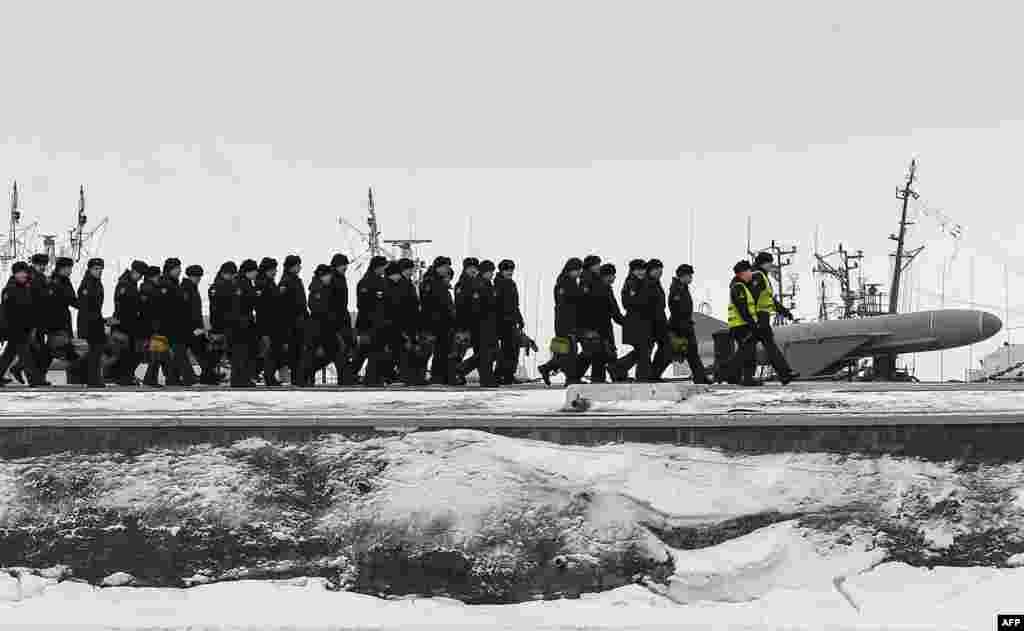 Russian naval cadets walk along a pier at the Kronshtadt Naval base outside St. Petersburg.