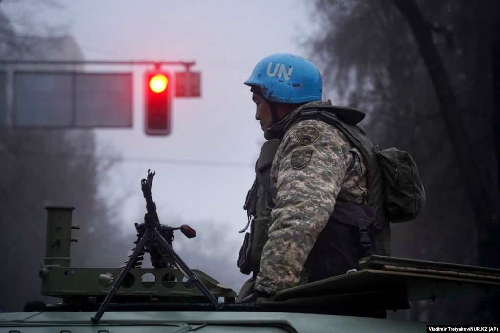 A Kazakh soldier stands near a belt-fed machine gun in Almaty on January 6. The images from Almaty in this story were released by AP on January 8.