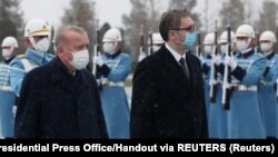 Turkish President Tayyip Recep Erdogan (left) and Serbian President Aleksandar Vucic review a guard of honor during a welcome ceremony for the latter's visit to Ankara on January 18. 