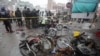 Members of a crime scene unit and a bomb disposal team gather after a blast at a market in Lahore on January 20.