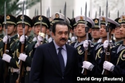Kazakhstan's then-prime minister, Karim Masimov, inspects an honor guard during an official welcoming ceremony in the Great Hall of the People in Beijing in 2002.