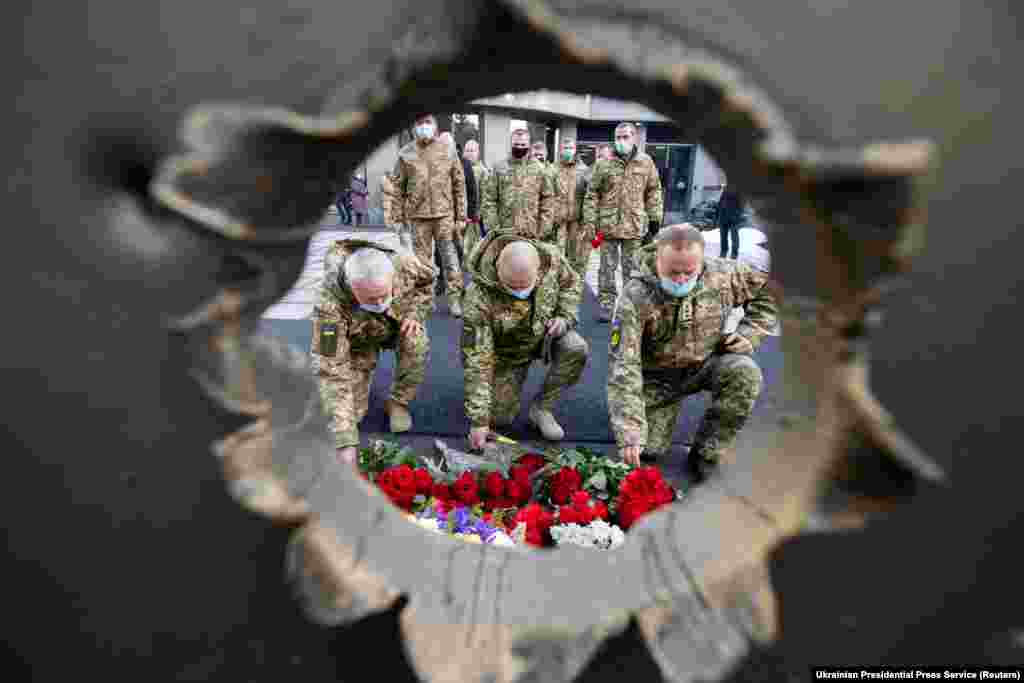 People attend a ceremony in tribute to fallen defenders of Ukraine, including soldiers killed during a battle with pro-Russia separatists for the Donetsk airport on January 20, 2015.