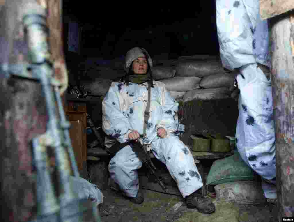 A Ukrainian service member sits near the line of separation from Russia-backed separatists outside the city of Horlivka in the Donetsk region.&nbsp;