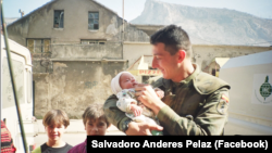 Pelaez holds an infant alongside other children in Mostar.